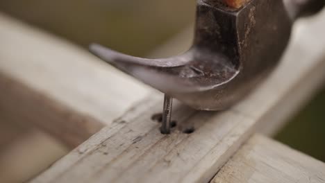 Zeitlupen-Nahaufnahme-Eines-Hammers,-Der-Einen-Nagel-Aus-Holz-Zieht