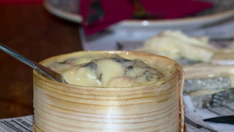 aged cheese in a wooden mold