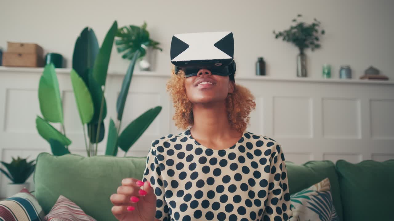 Attractive young woman having fun at home in virtual reality glasses