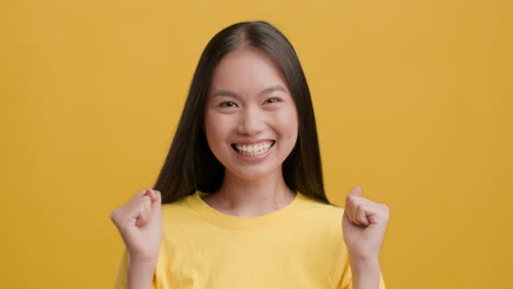 happy young asian woman celebrating success
