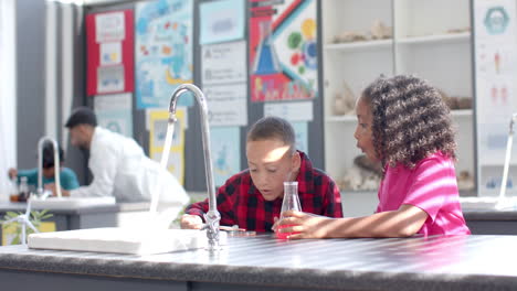 in a school science lab, a diverse group of students is engaged in an experiment
