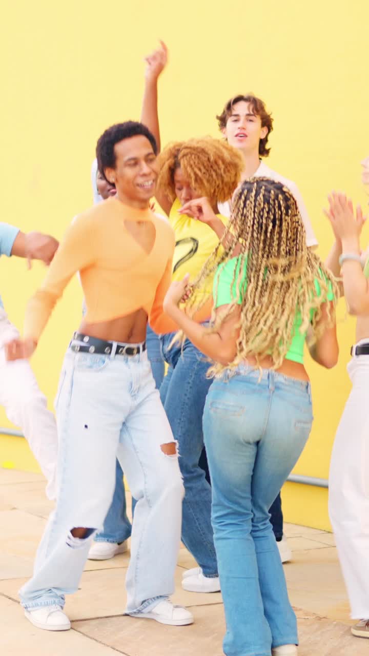 Multicultural friends dancing together in the city
