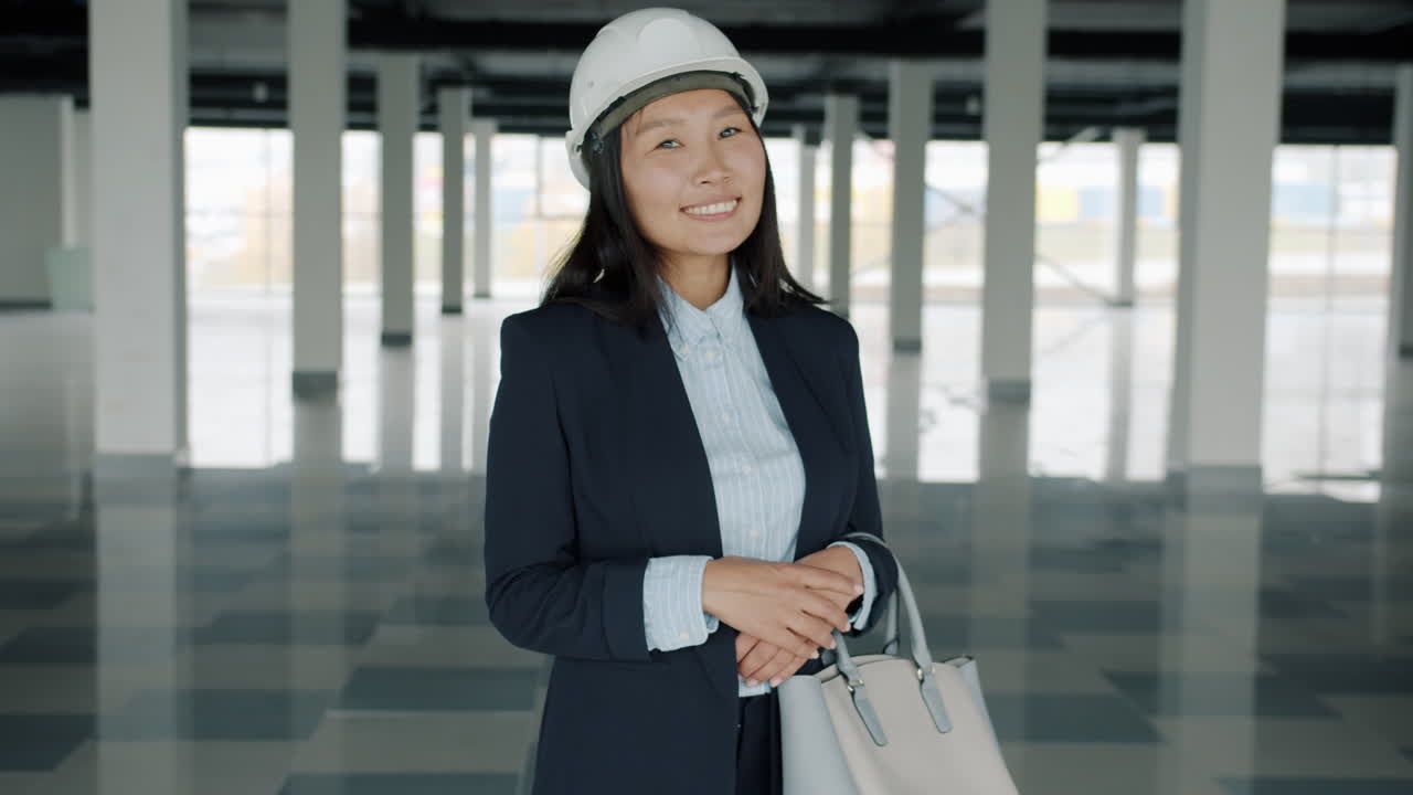 Smiling Woman Engineer in Empty Office Building