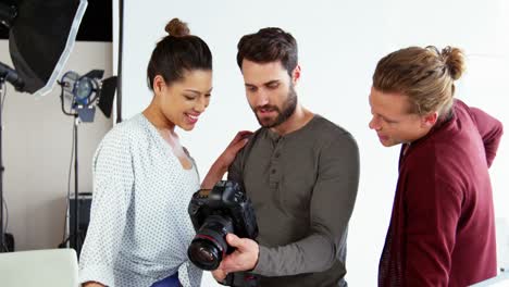 photographer showing photos to fashion model