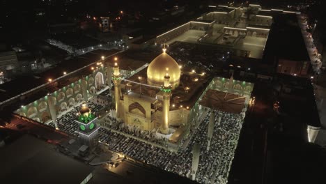 drone shot of imam ali holy shrine in iraq during prayer, capturing the serene ambiance, worshippers gathered, and intricate architecture bathed in soft light