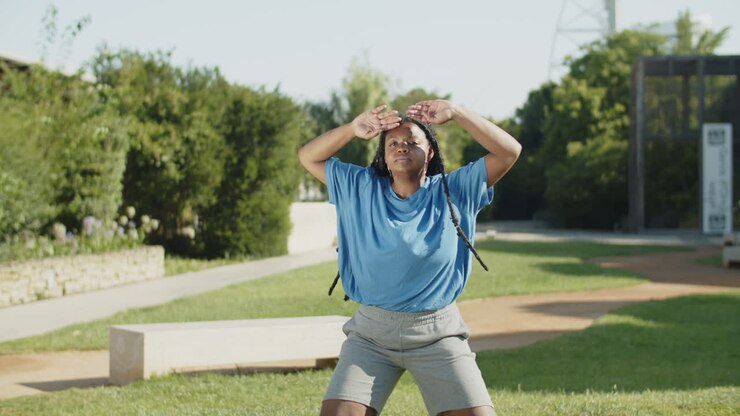 Front view of African-American woman doing jumping jacks