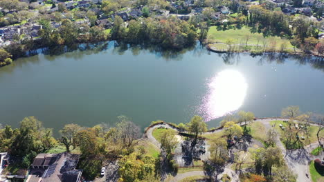 an aerial drone view of grant pond in a long island, ny suburb