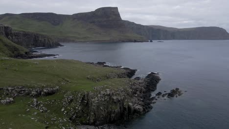 4k aerial drone footage zooming in on rocky coastline at neist point in scottish highlands scotland uk