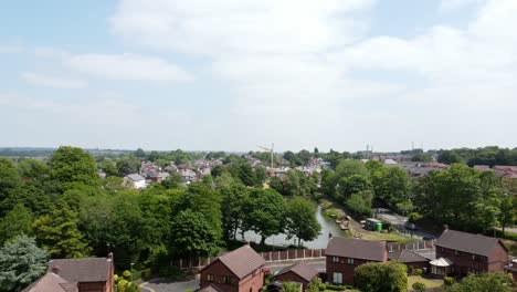 suburban woodland red brick british townhouse development neighbourhood aerial view above detached property