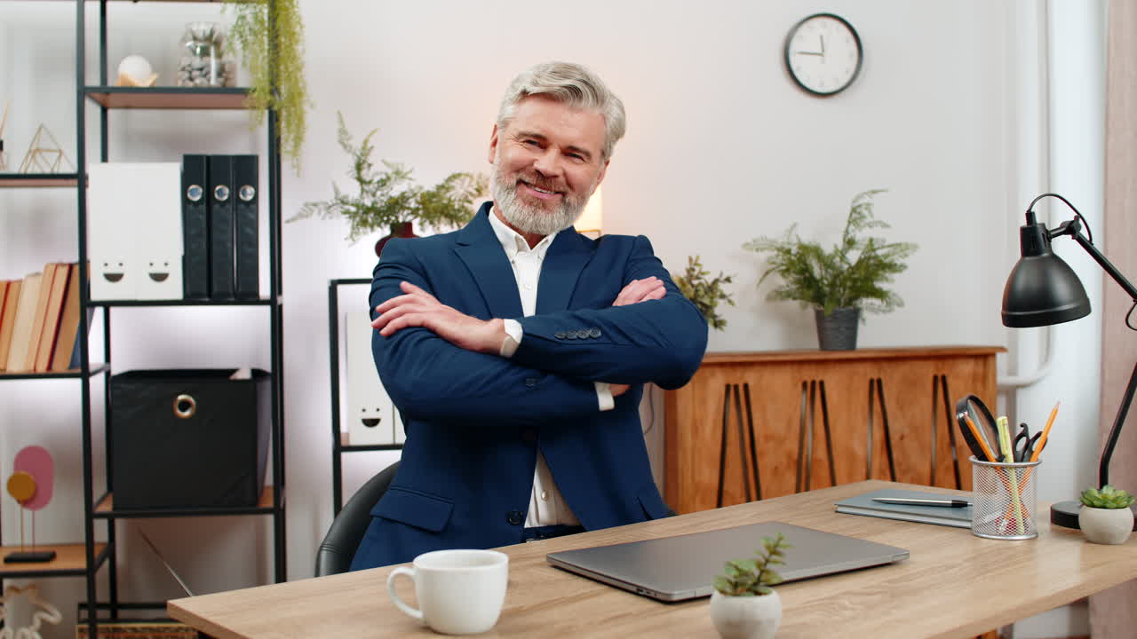 Middleaged businessman closes laptop crosses arms proud gazing camera satisfied project completion