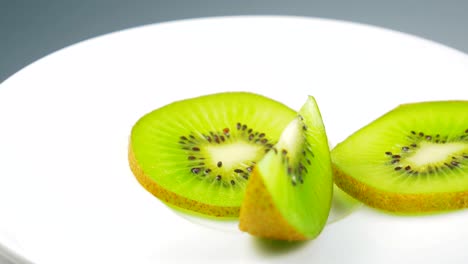 fresh kiwi slice is slowly rotating in the studio with the details.