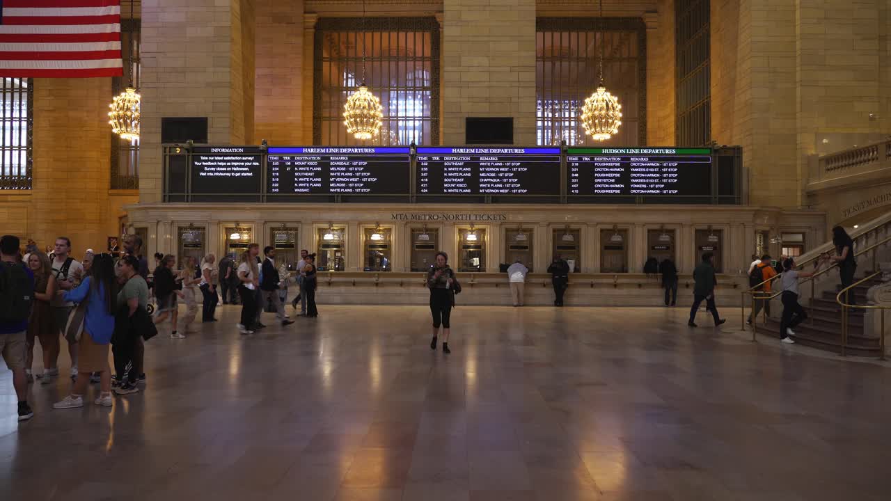 Wide shot of Grand Central Terminal’s Main Concourse, bustling with commuters and tourists
