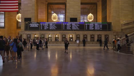 wide shot of grand central terminal’s main concourse, bustling with commuters and tourists