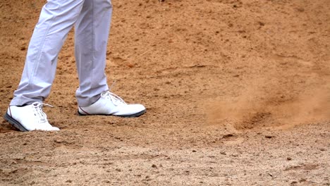 slow motion golf concept, golfer playing golf ball in golf course. player swing slow hitting ball on sand bunker.