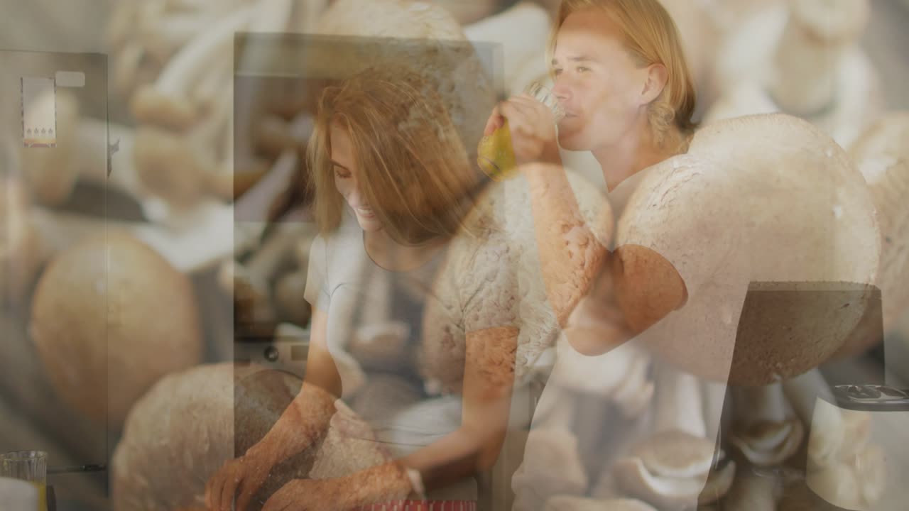 Woman kissing man at kitchen counter starting stirring, pouring, chopping for cooking