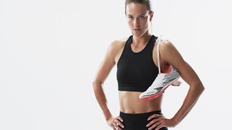 Young-Caucasian-athlete-woman-poses-confidently-in-sportswear,-with-copy-space-on-a-white-background