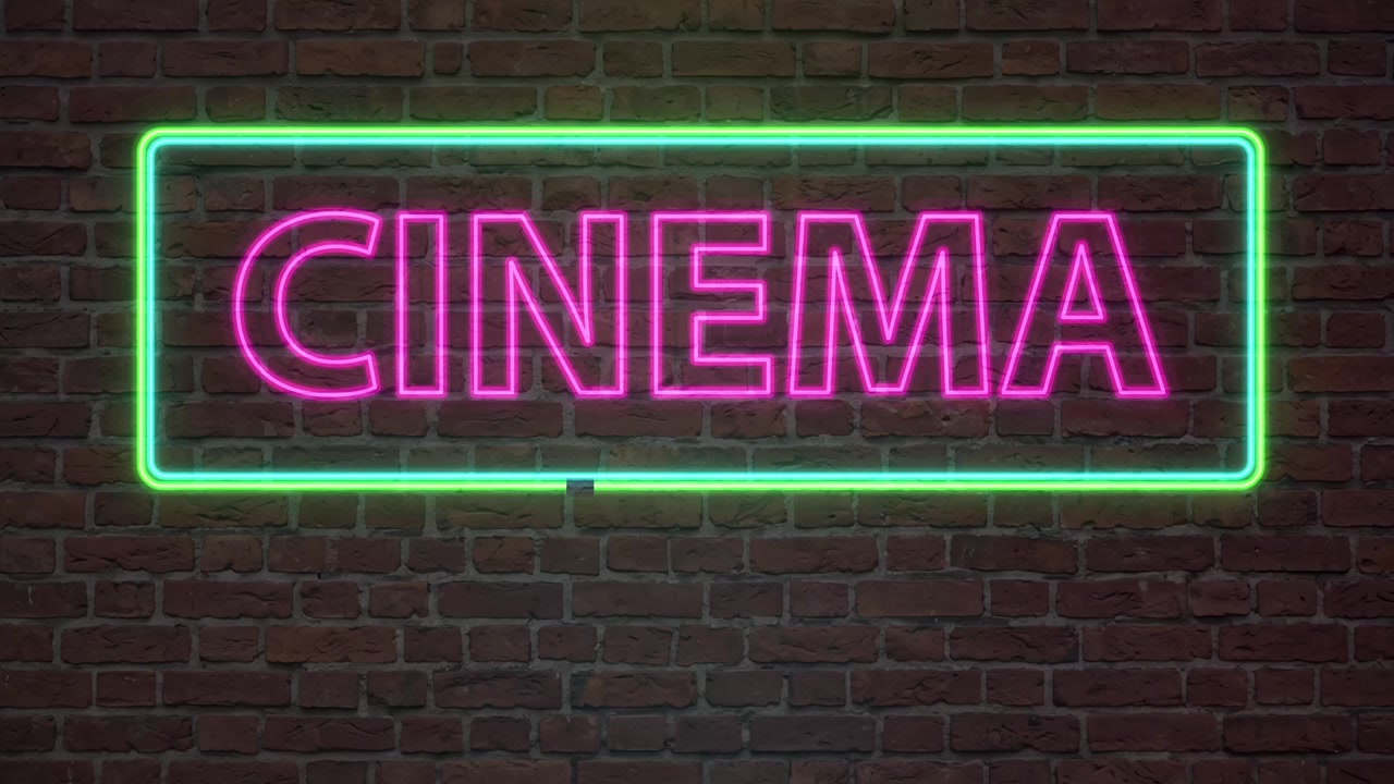 Testo cinematografico rosa luminoso all'interno di una cornice al neon verde sfarfalla su uno sfondo di mattoni scuri.