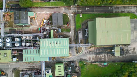 aerial footage zooms in on a uk industrial chemical plant, highlighting pipelines, metal constructions, cooling towers, and chemical storage