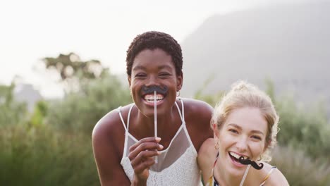 portrait of happy african american married woman with caucasian female friend