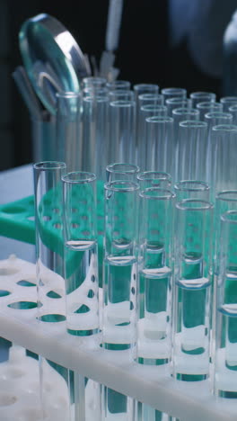 scientist handling test tubes in a laboratory