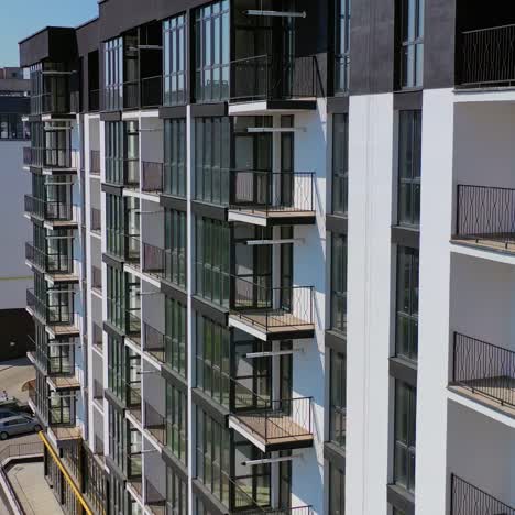 new architecture in the city. high-raise apartment buildings near the road. modern design of multistorey building. drone flight.