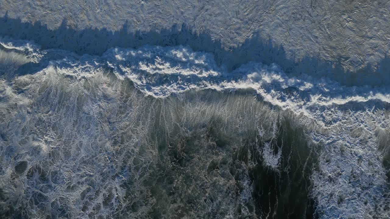 Waves breaking on the shoreline