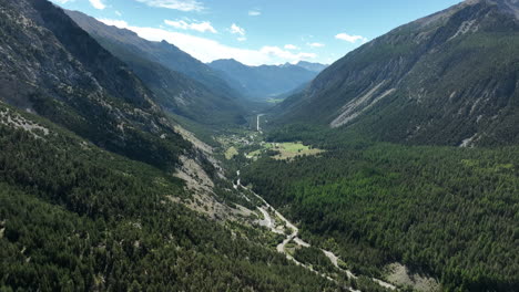 Summer-in-the-mountain-french-alps-aerial-shot-green-grazing-with-dirt-road