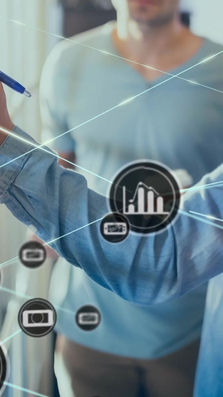 Animation of connected icons over caucasian man holding coffee cup explaining strategy to coworkers