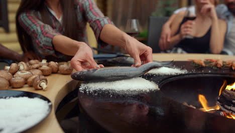 바에서 bbq 물고기를 준비하는 여자