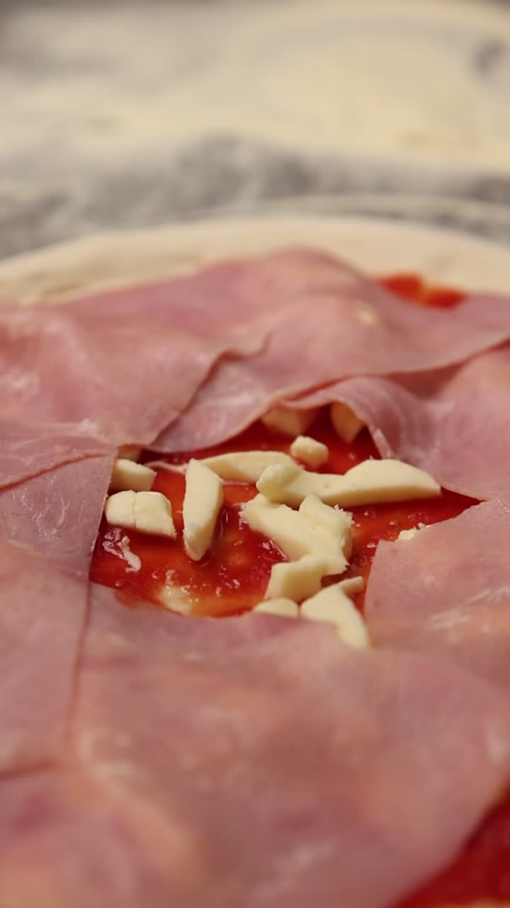 Aggiungere fette di prosciutto a una pizza cruda