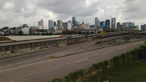 Aerial-Over-Houston,-Texas-Highway-with-Downtown-Skyline-in-Distance