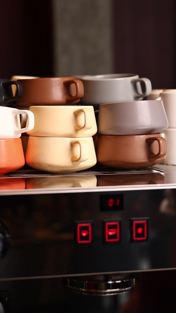 Stacked Ceramic Coffee Cups on a Professional Espresso Machine