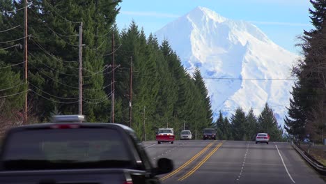 cars and trucks travel on a highway below mt hood oregon