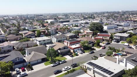 Aerial-shot-of-houses-in-a-residential-area-on-a-warm,-sunny-day,-concept-for-housing-market-and-real-estate-investment