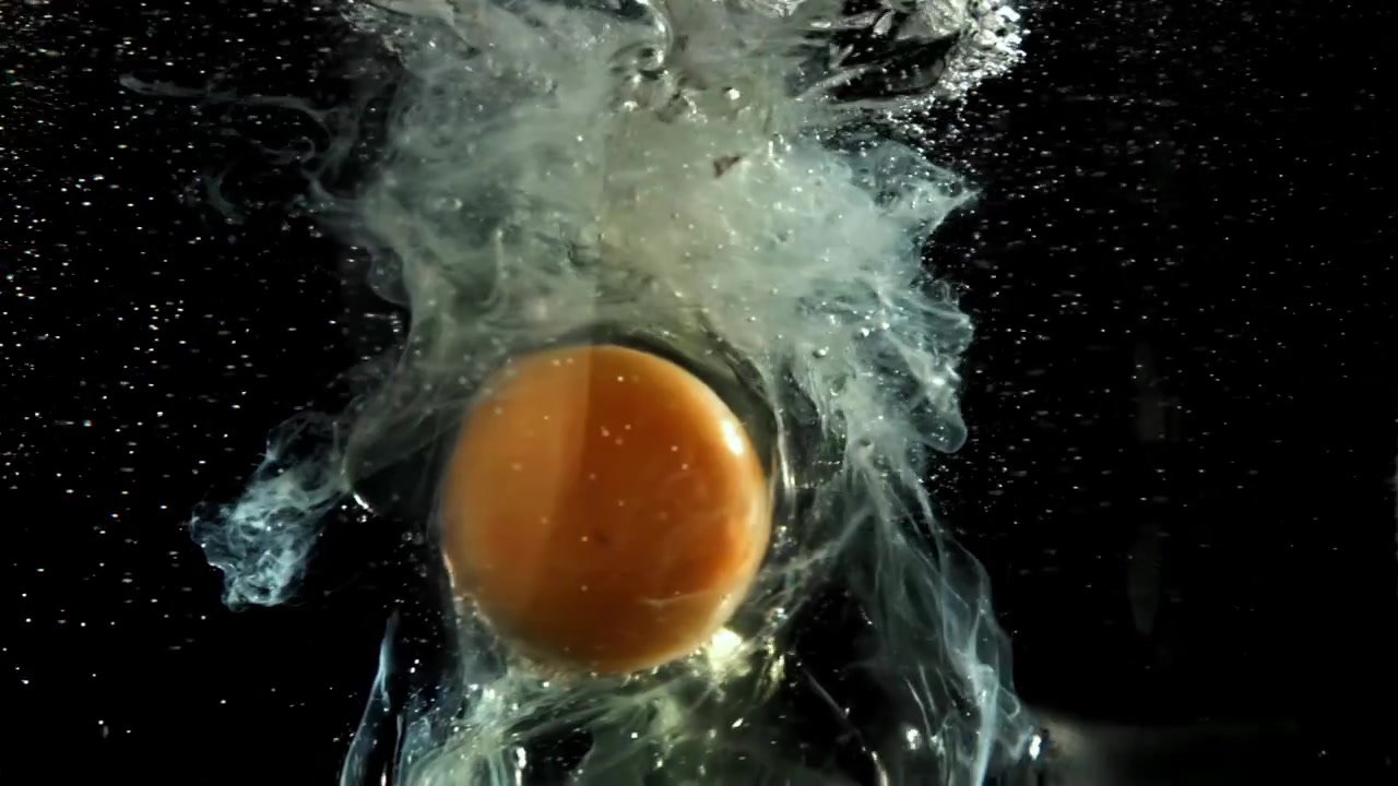 Raw Egg Yolk and White Dispersing in Water in Slow Motion