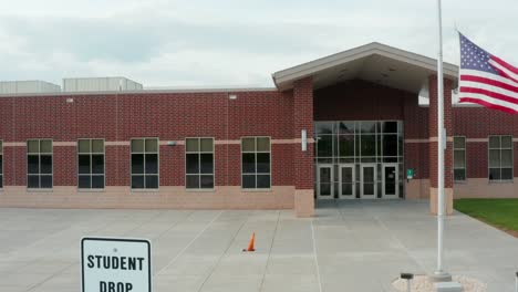 american school building, student drop off zone sign