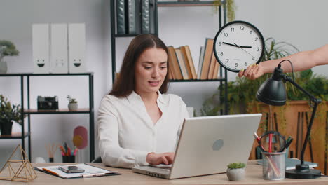 young businesswoman with anxiety checking time on clock running late to work being in delay deadline