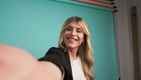 happy transgender businesswoman puckering lips while taking selfie in studio
