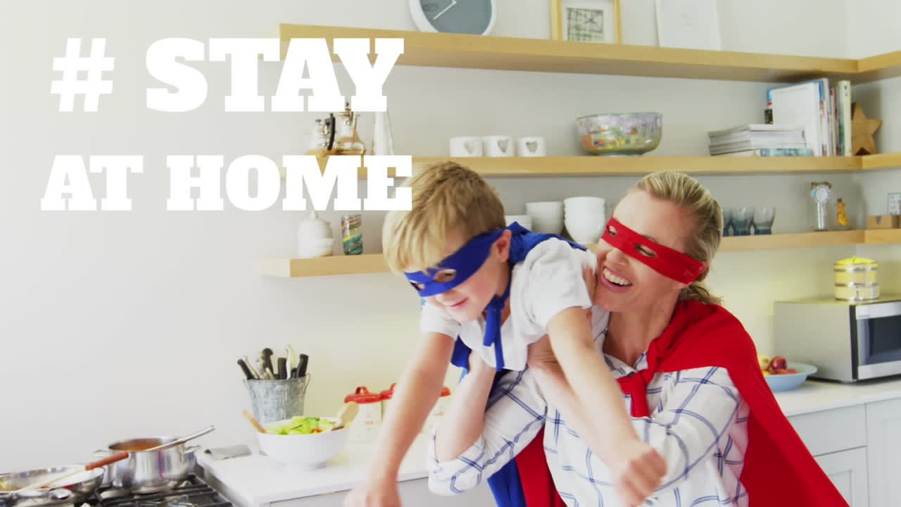 Caucasian woman and her son wearing a cape with words Stay Home