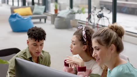Busy diverse business people working on computer and talking in slow motion