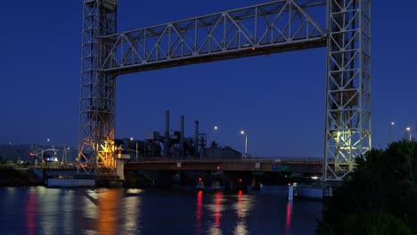 the miller sweeney bridge glows beneath fading skies as the flow of vehicles are captured in motion, highlighting the daily tempo of life in alameda’s working harbor.