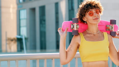 young woman with pink skateboard