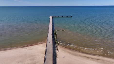 aerial view a bridge standing on the beach of palanga, which goes to the baltic sea