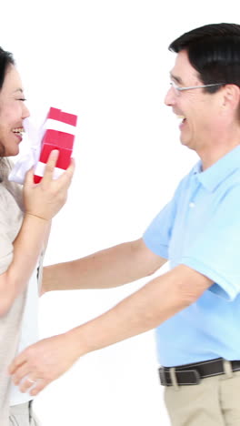 asian man giving a gift to his wife