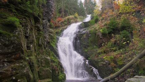 a beautiful waterfall in the middle of an autumn forest a beautiful waterfall in the middle of an autumn forest