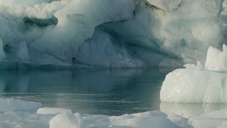 glacier lagoon, jökulsárlón, iceland, with icebergs and flowing icy blue water