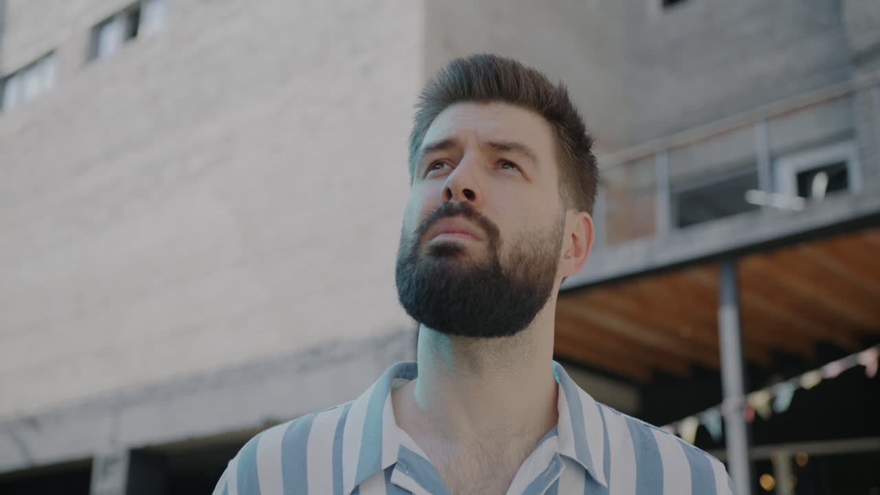 Man Looking Up in City