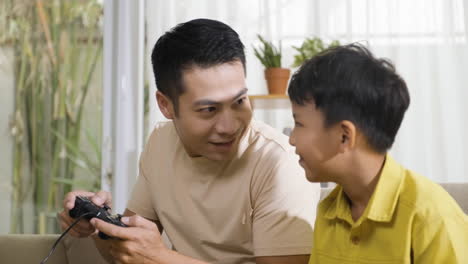 asian man and boy in the living room