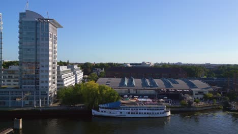 unbelievable aerial top view flight bathing pool ship on border river spree, west berlin germany evening summer 23