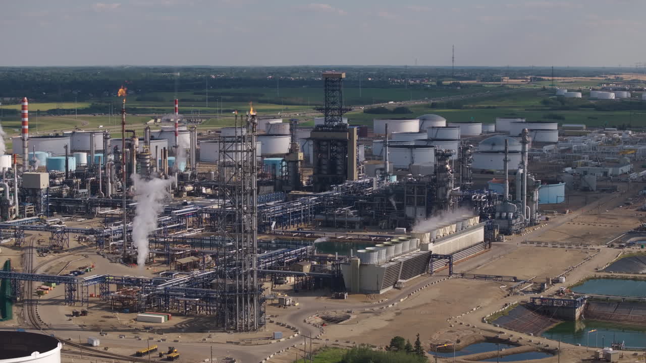 Aerial view of industrial refinery, vast machinery under sunny skies
